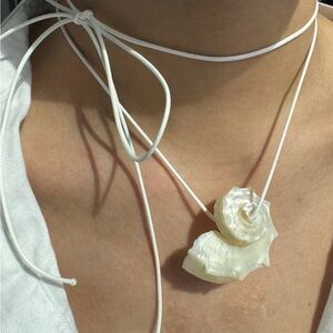Minimal coastal shell pendant necklace with soft white cord wrap detail 🤍